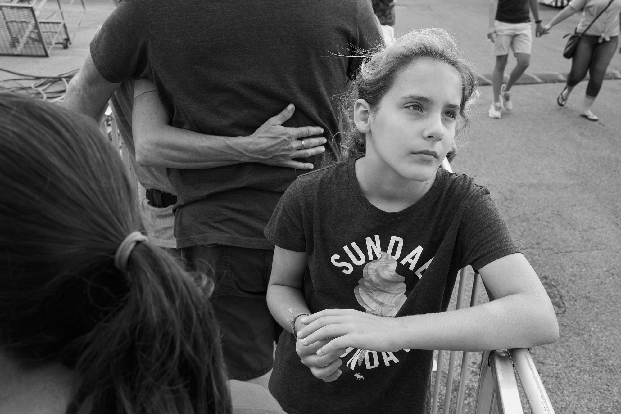 A girl daydreaming while waiting in line at the OH State Fair.