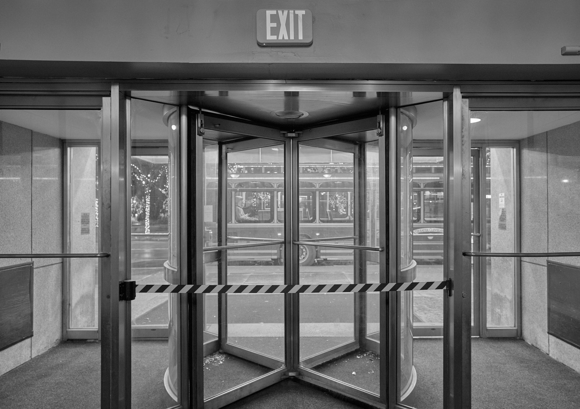 Rotating door with exit sign in a hotel interior