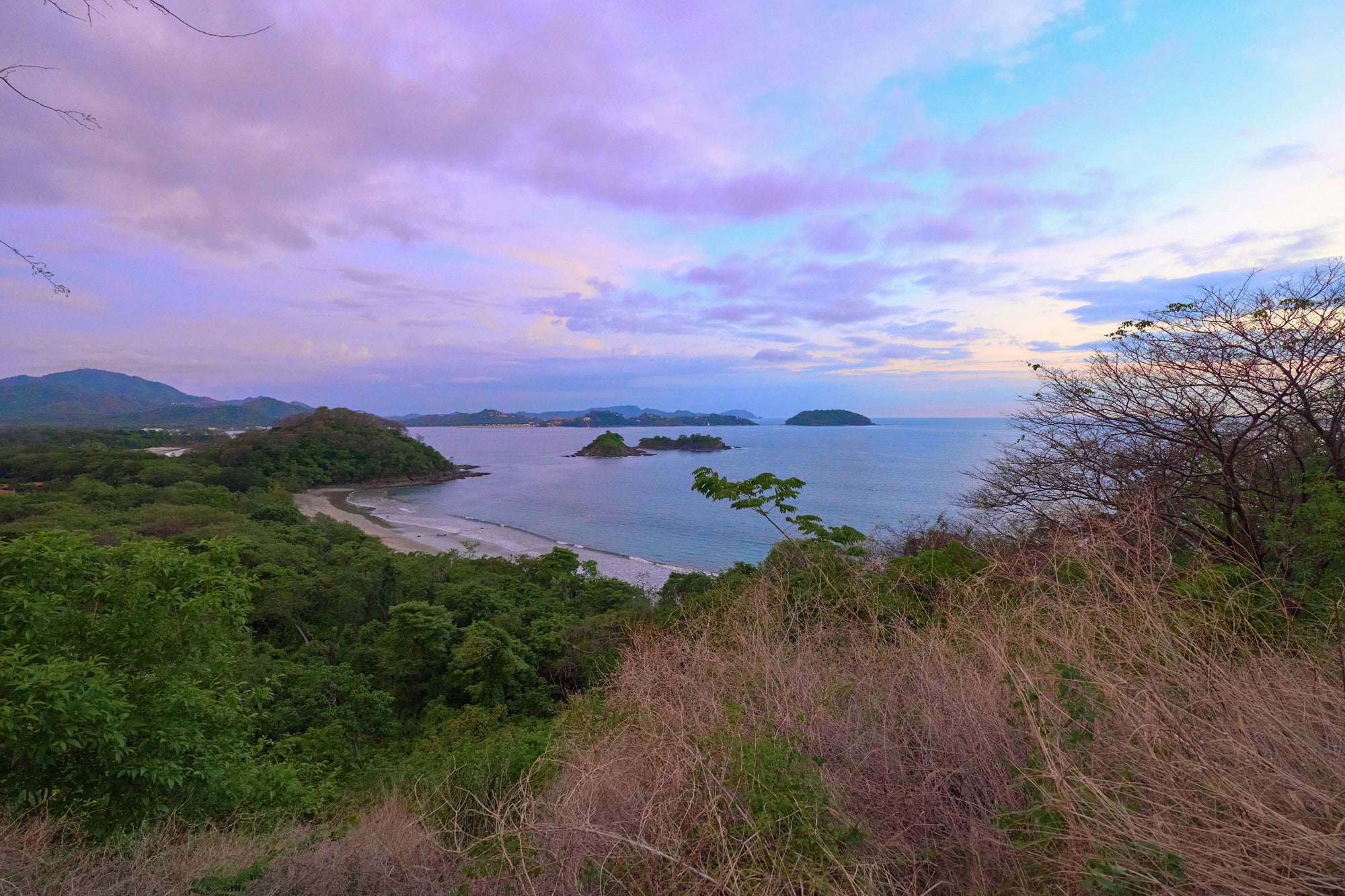 Dusk view of Playa Prieta from Mirador observation area with vibrant sky.